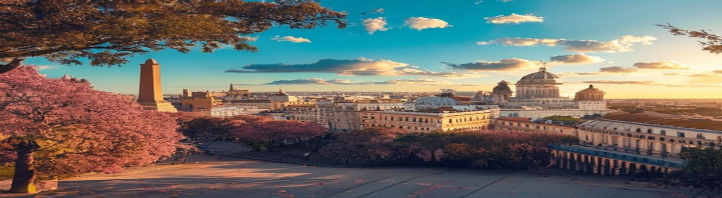 Buenos Aires at golden hour — the Obelisco, domed rooftops, jacarandas in bloom